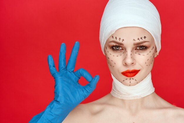 A surgeon in a modern operating room in Tunisia consulting a 3D imaging screen during a plastic surgery procedure