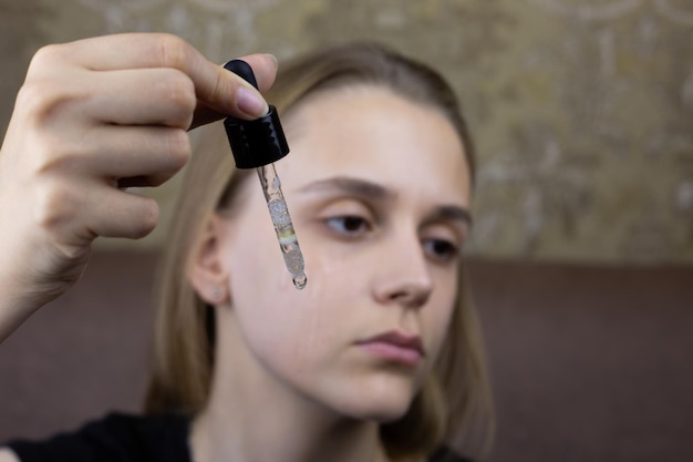 A woman applying mandelic acid serum to her face in a modern aesthetic clinic in Tunisia