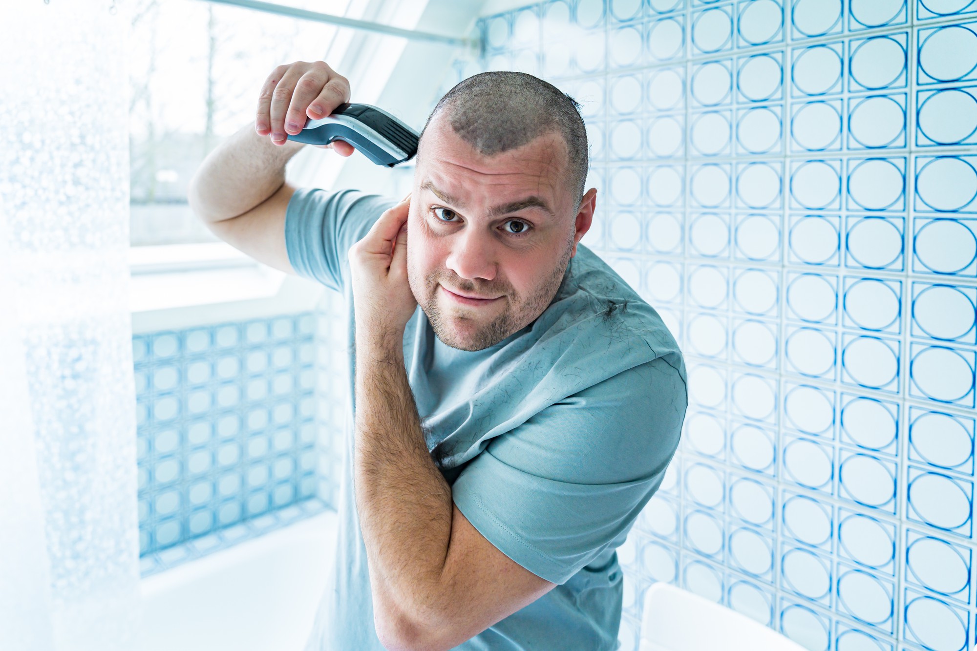 Smiling man after successful hair transplant in Tunisia with modern clinic background